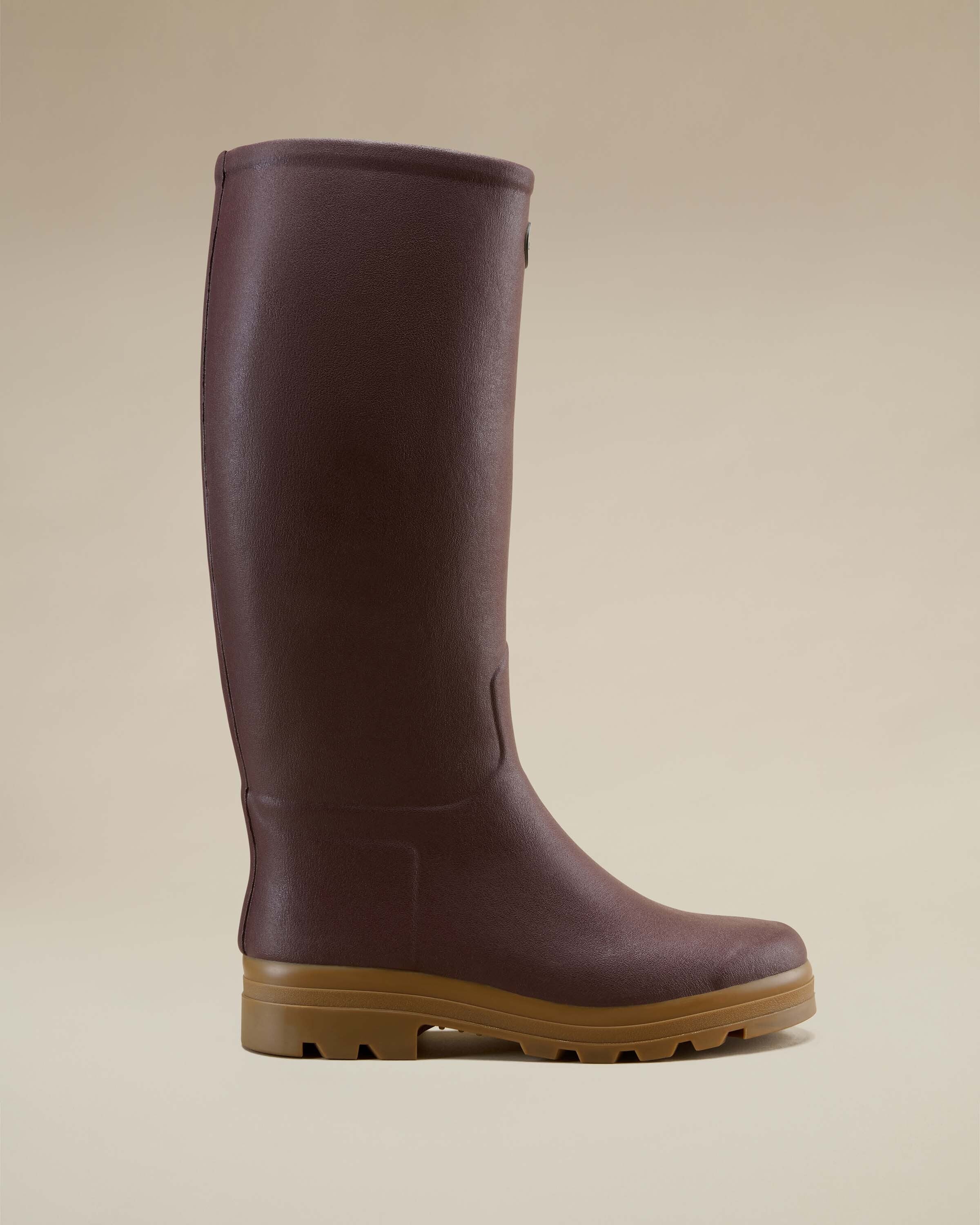 A side view of one Men's Saint Hubert Leather Lined Wellington Boot in Brown on a soft beige background. The boot's clean lines, supportive heel structure, and sole grip are clearly visible.