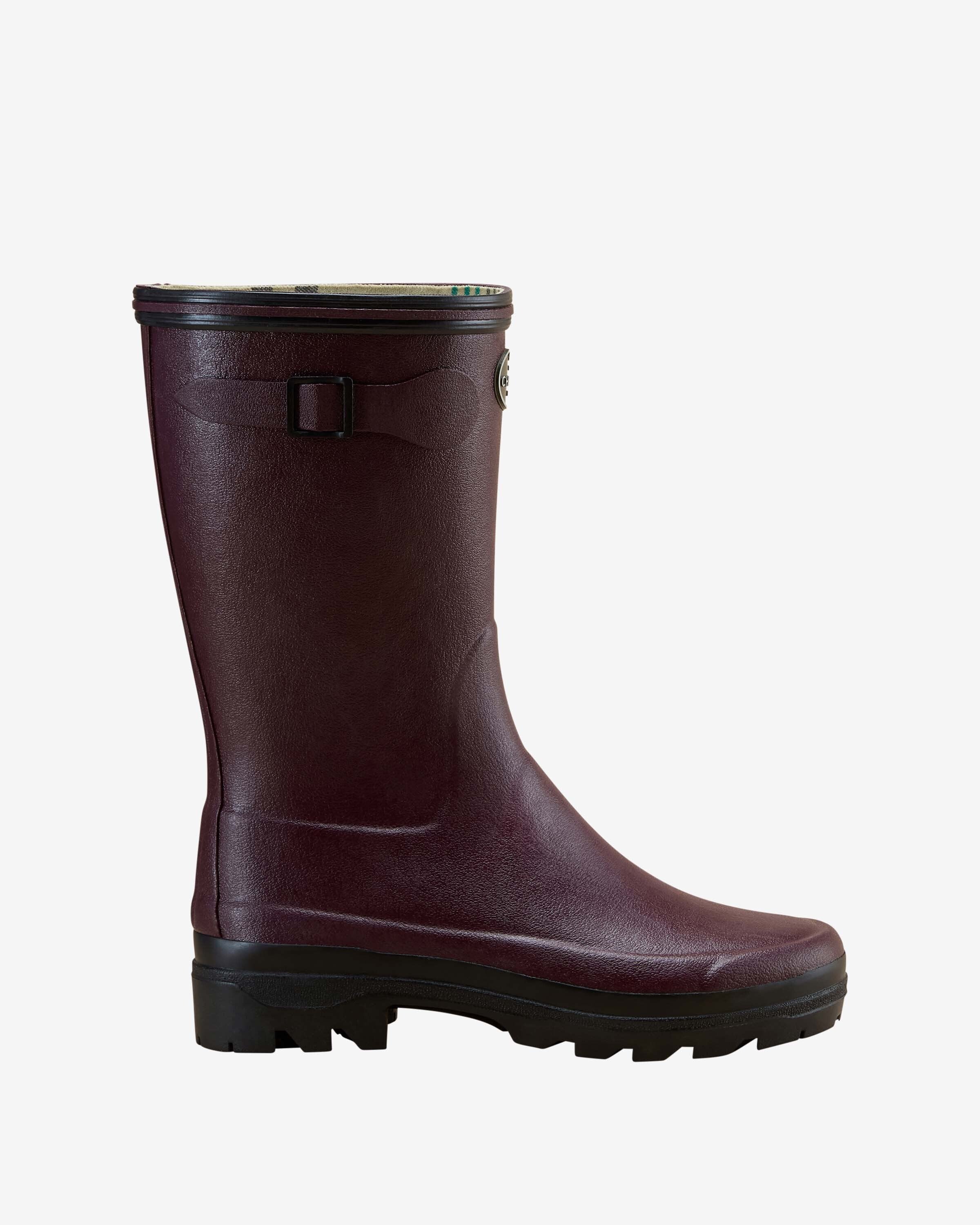 Side profile of a single Women's Giverny Jersey Lined Bottillon in Cherry Red. Displayed against a white background, the boot features a mid-calf height, matte textured finish, a black adjustable side buckle strap, and a chunky black rubber sole with defined treads.