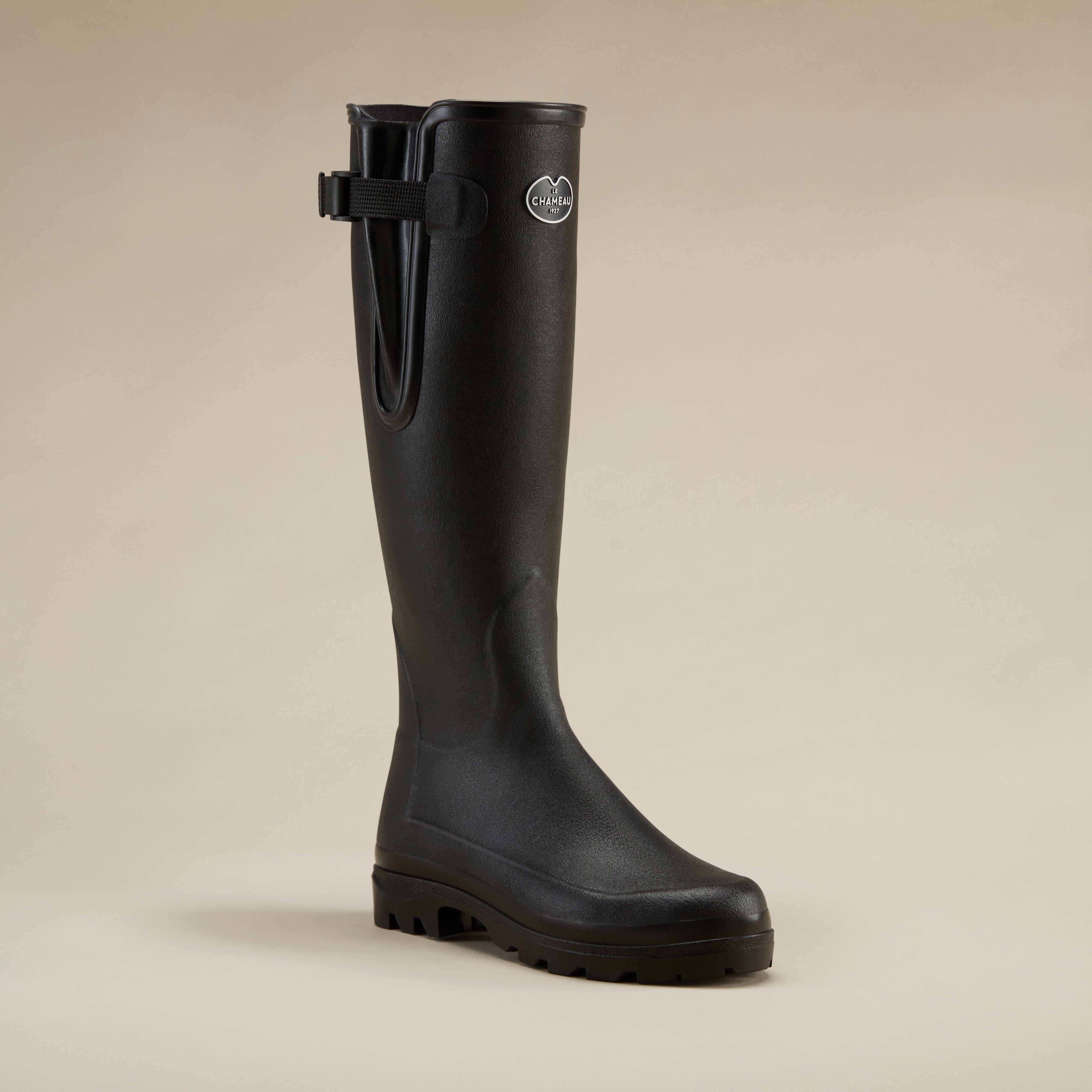 Single Women's Vierzonord Neoprene Lined Wellington Boot in Black shown at a 45-degree angle on a beige background, highlighting the contoured ankle fit and premium matte rubber exterior.