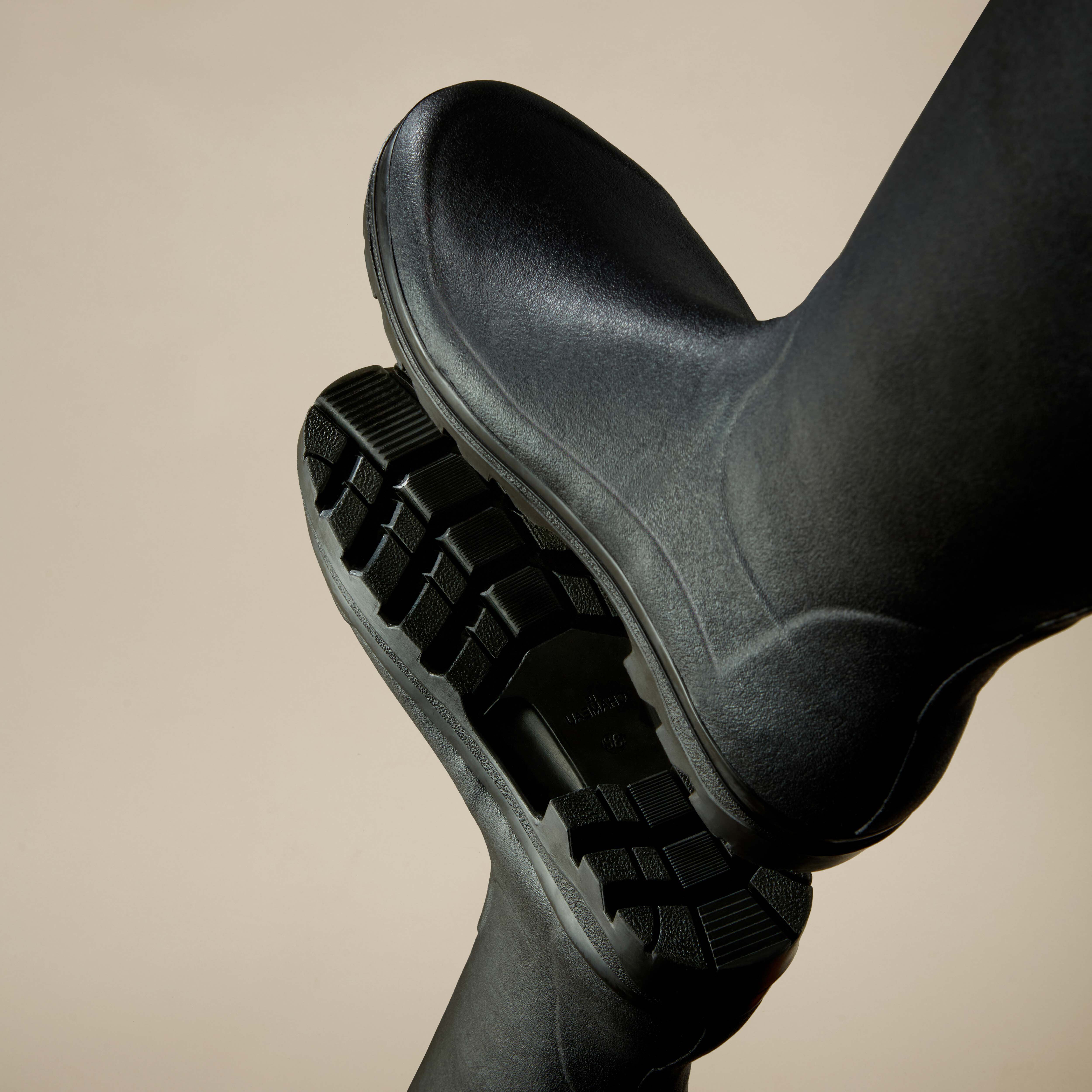 Detailed view of the outsole of the Women's Vierzonord Neoprene Lined Wellington Boot in Black, showing the multi-directional tread pattern for enhanced traction and stability.