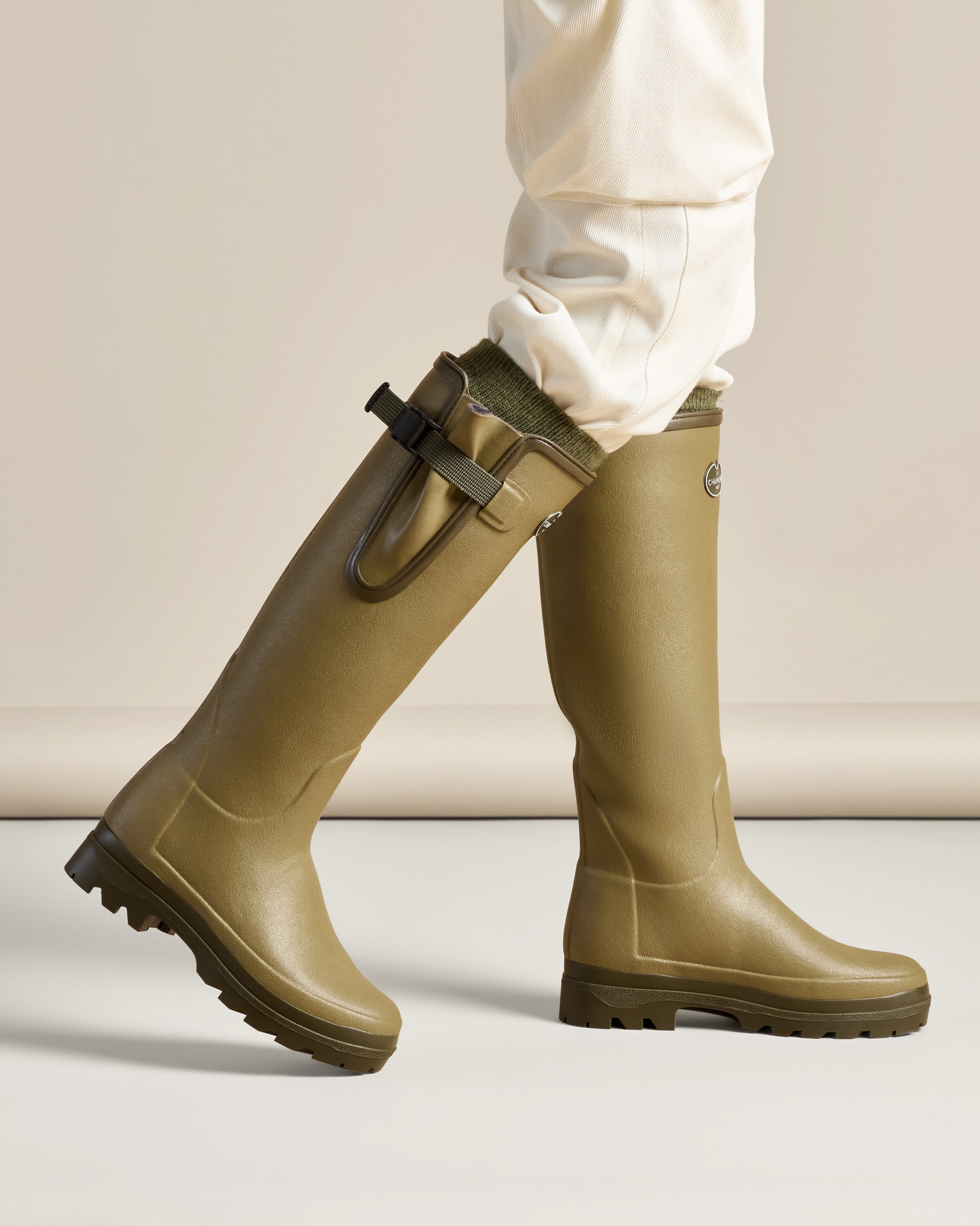 A Women's Vierzonord Neoprene Lined Wellington Boot in Iconic Green is positioned in a clean, studio-lit side view. This image offers a clear look at the profile, from the gently sloped toe to the mid-ankle contour line and back to the gusset strap and heel.