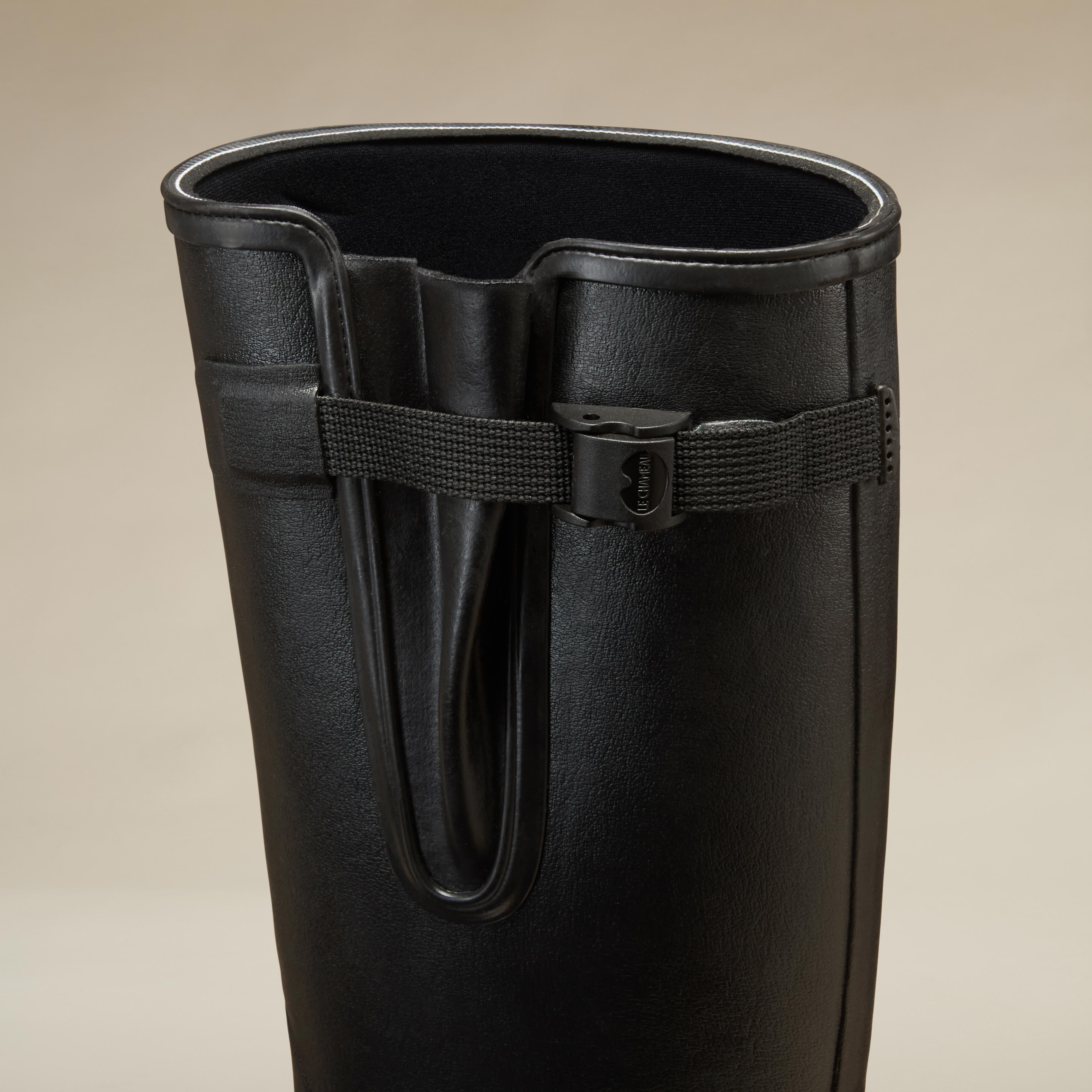Close-up of the gusset area of the Men's Vierzonord Neoprene Lined Wellington Boot in Black, focusing on the adjustable black strap and the inner neoprene lining. The detail shot reveals the logo embossing on the buckle and the secure construction of the gusset fold.