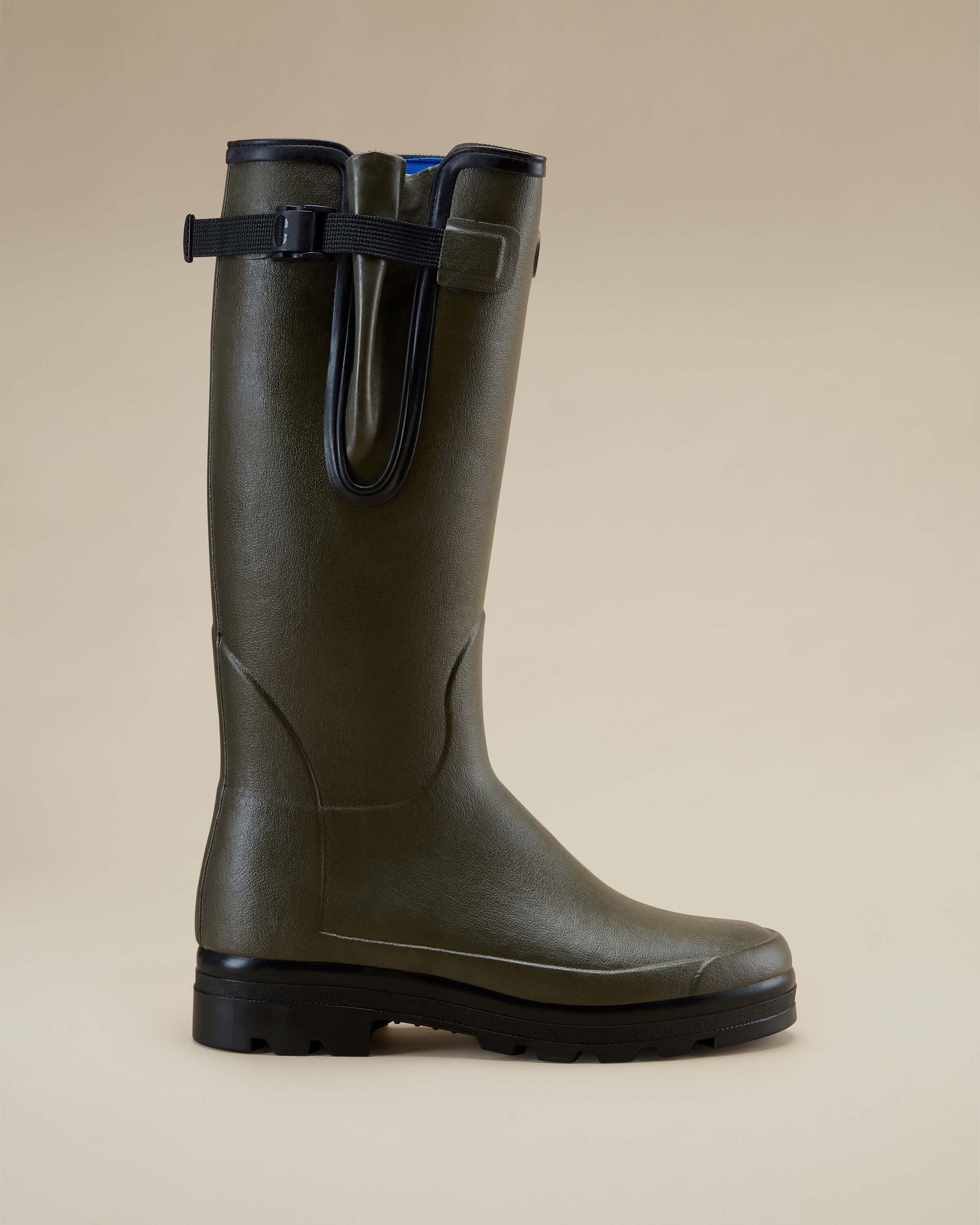Side view of the Men's Vierzonord Neoprene Lined Wellington Boot in Chameau Green, shown upright on a soft tan background. The focus is on the streamlined silhouette, side gusset, and matte rubber finish, ideal for wet or muddy terrains.