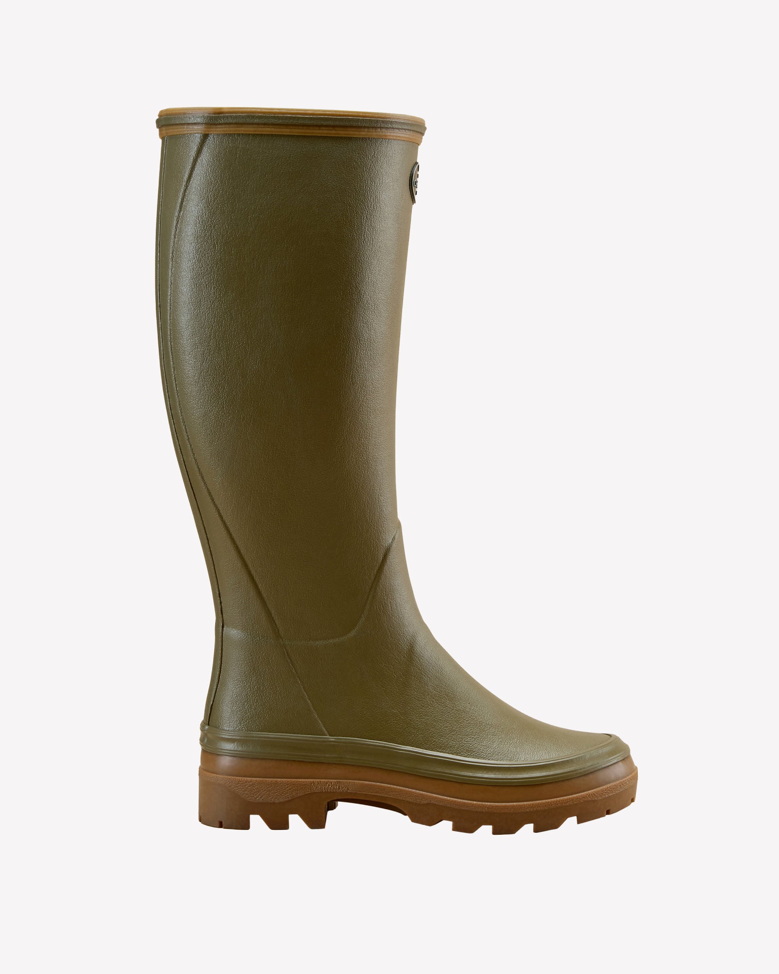 A single Women's Giverny Jersey Lined Wellington Boot in Iconic Green is displayed in a right-side profile view against a white background. The tall boot has a natural rubber exterior with a smooth texture, a light brown dual-density sole for traction, and a slightly flared shaft opening. The Le Chameau logo badge is visible near the top of the boot shaft.
